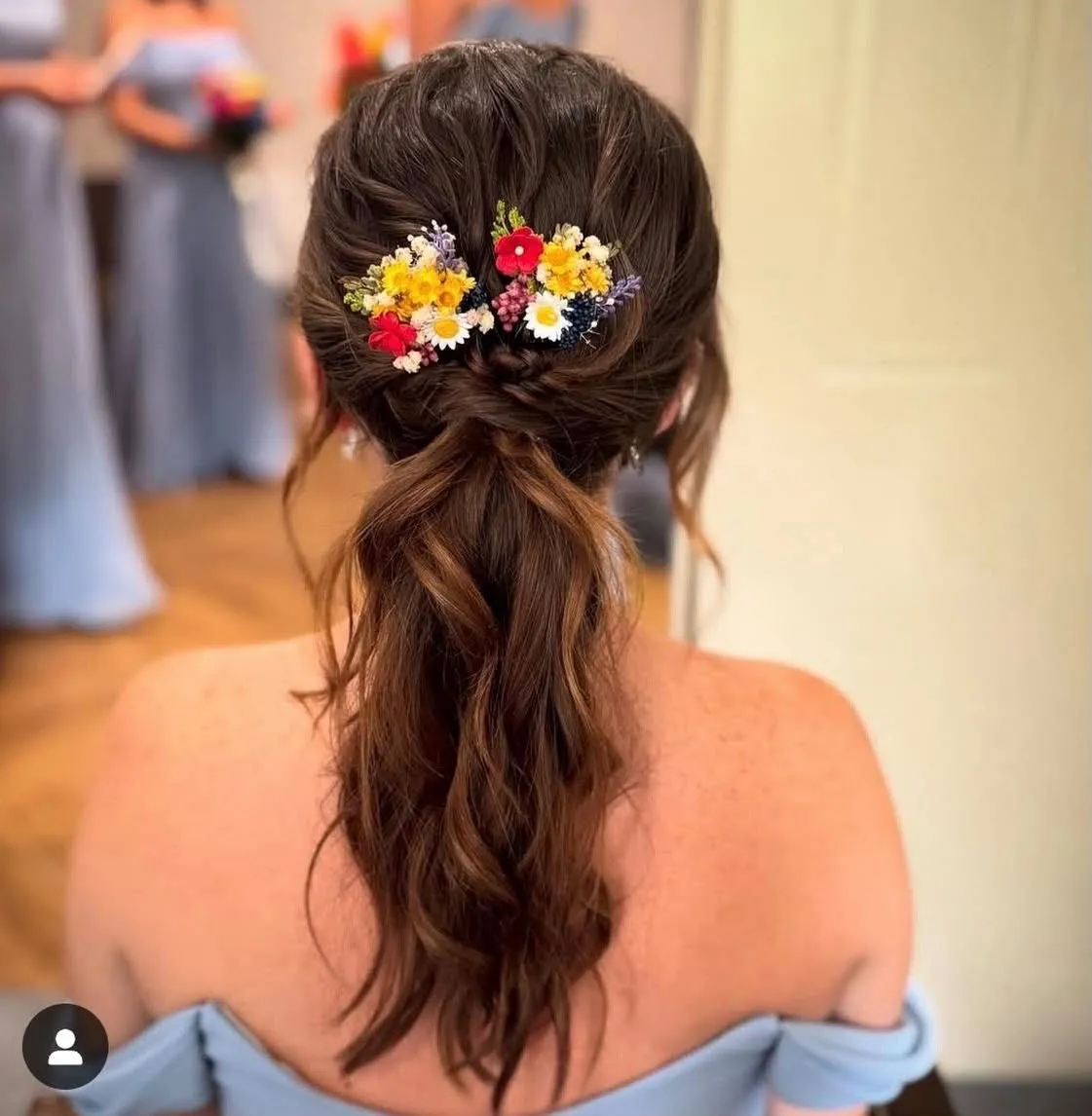 Bridesmaid's waved ponytail with colourful wildflower hair pins by Be Bridal