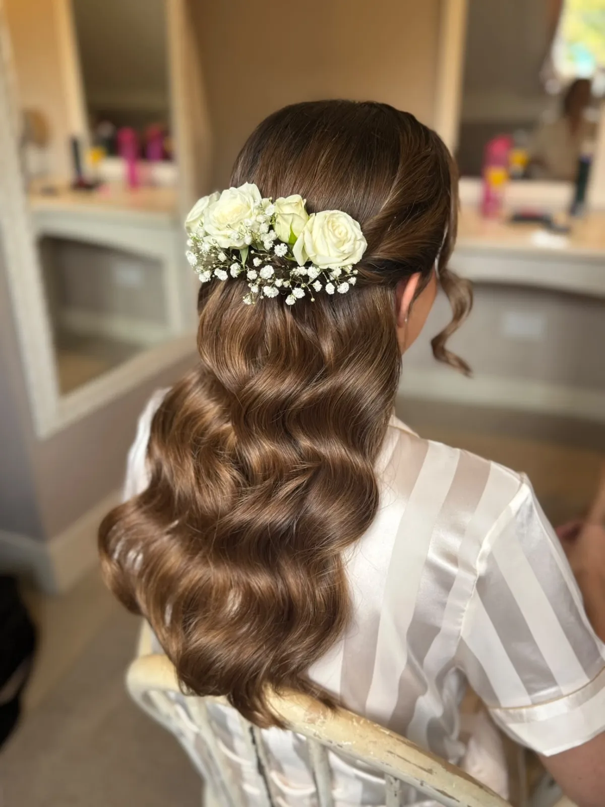 Long Hollywood waves with a white rose and gypsophila hairpiece by Be Bridal