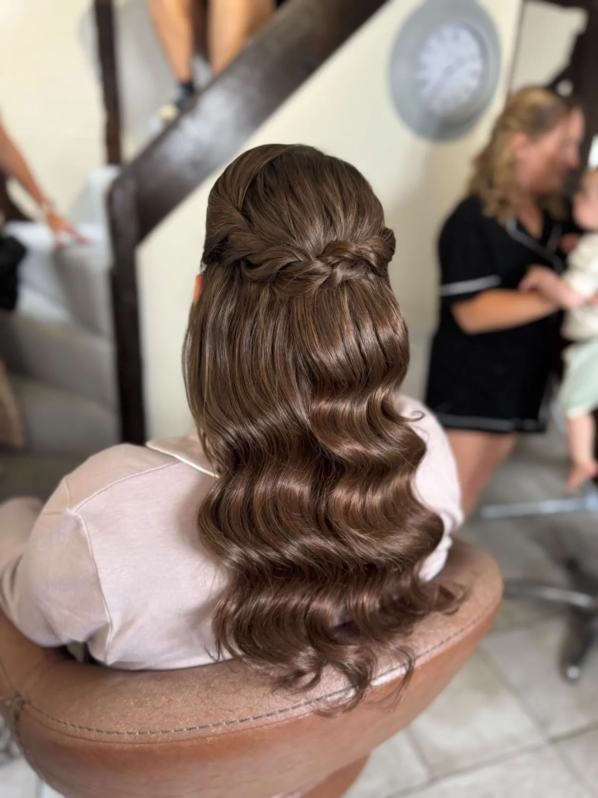 Half-up glossy brunette waves with a twisted crown detail by Be Bridal