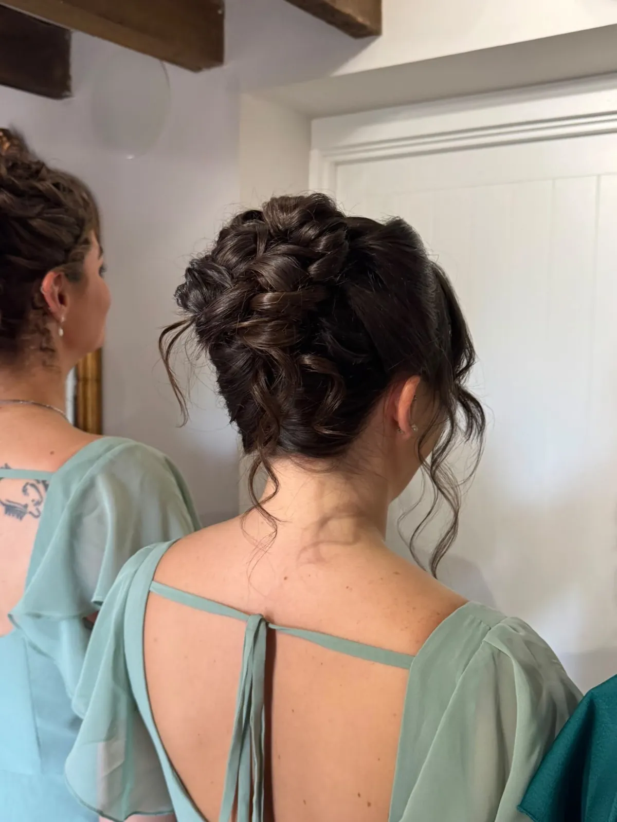 Bridesmaid's textured curly updo with loose tendrils by Be Bridal