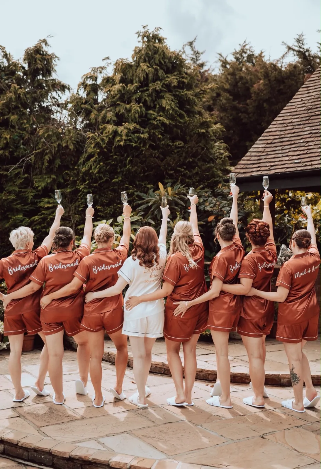 Bride and bridal party raising a champagne toast on the wedding morning by Be Bridal