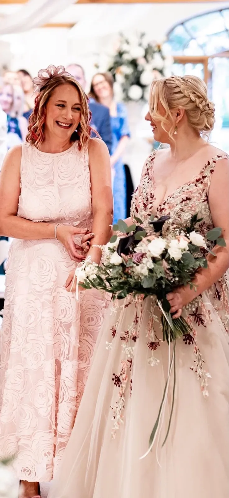 Bride with a braided updo walking down the aisle by Be Bridal