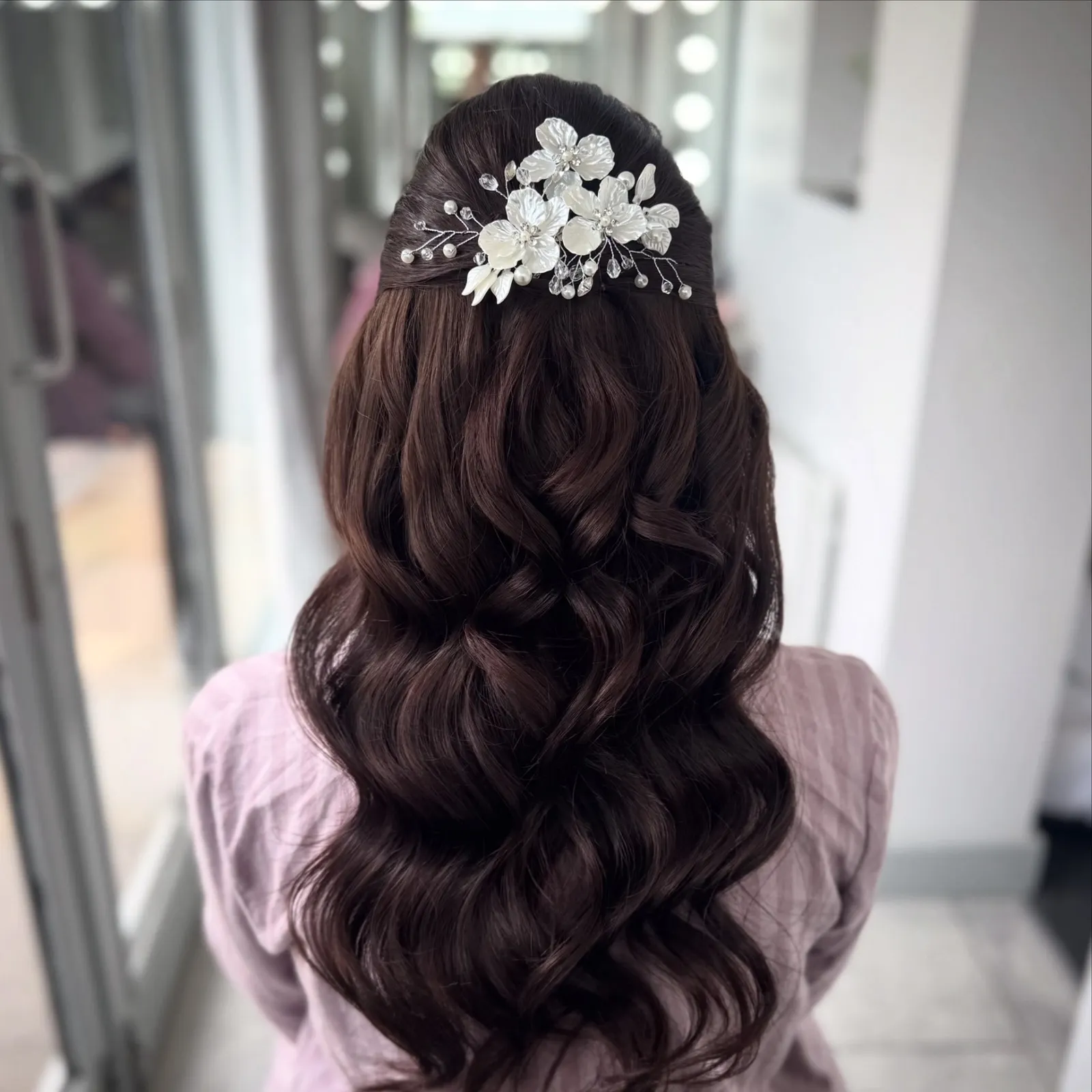 Long dark Hollywood waves with a pearl floral bridal comb by Be Bridal