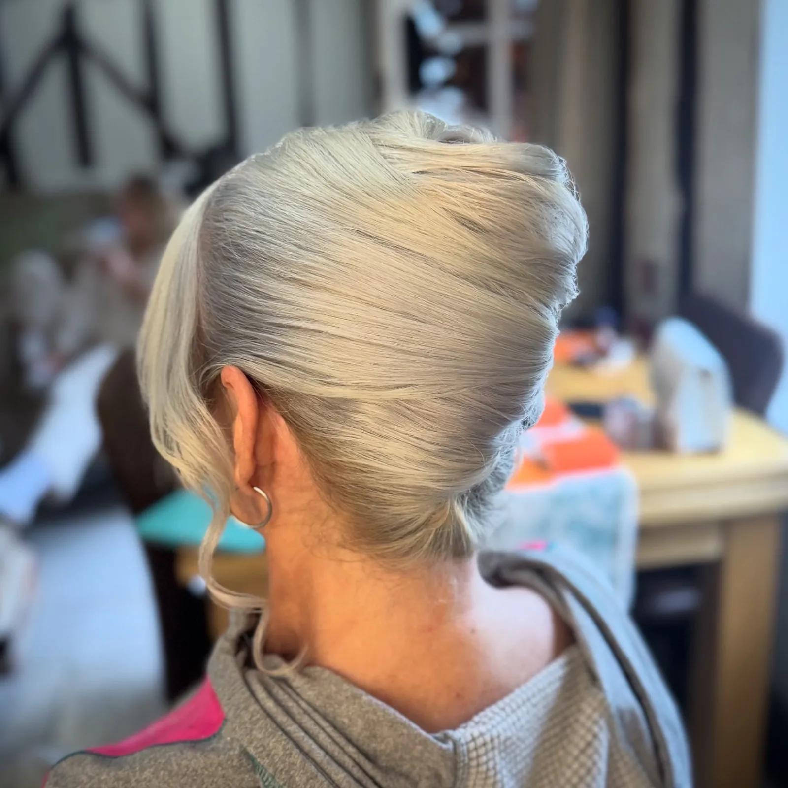 Sleek silver French twist for the mother of the bride by Be Bridal