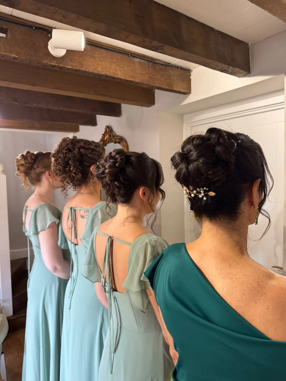 Bridesmaids and mother of the bride showing matching updos by Be Bridal