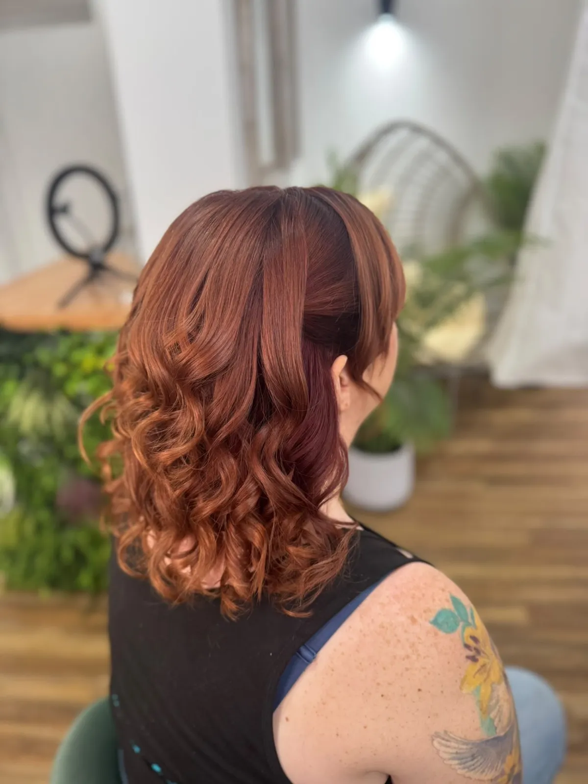 Glossy copper curls with a sleek swept-back crown by Be Bridal