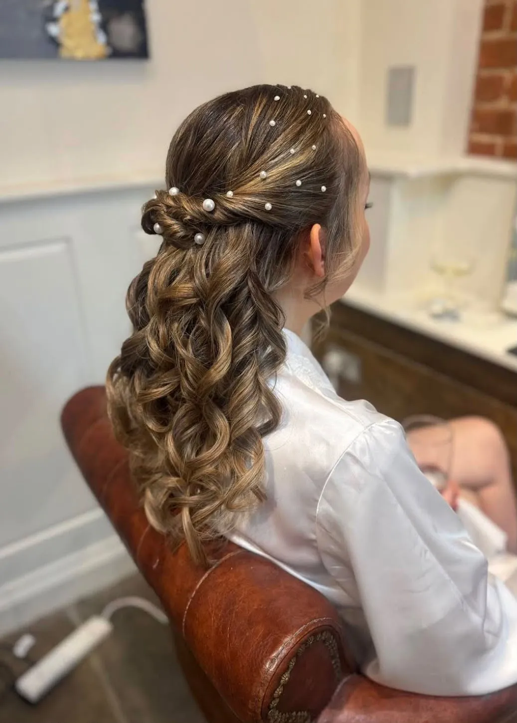 Half-up bridal curls scattered with pearl pins by Be Bridal