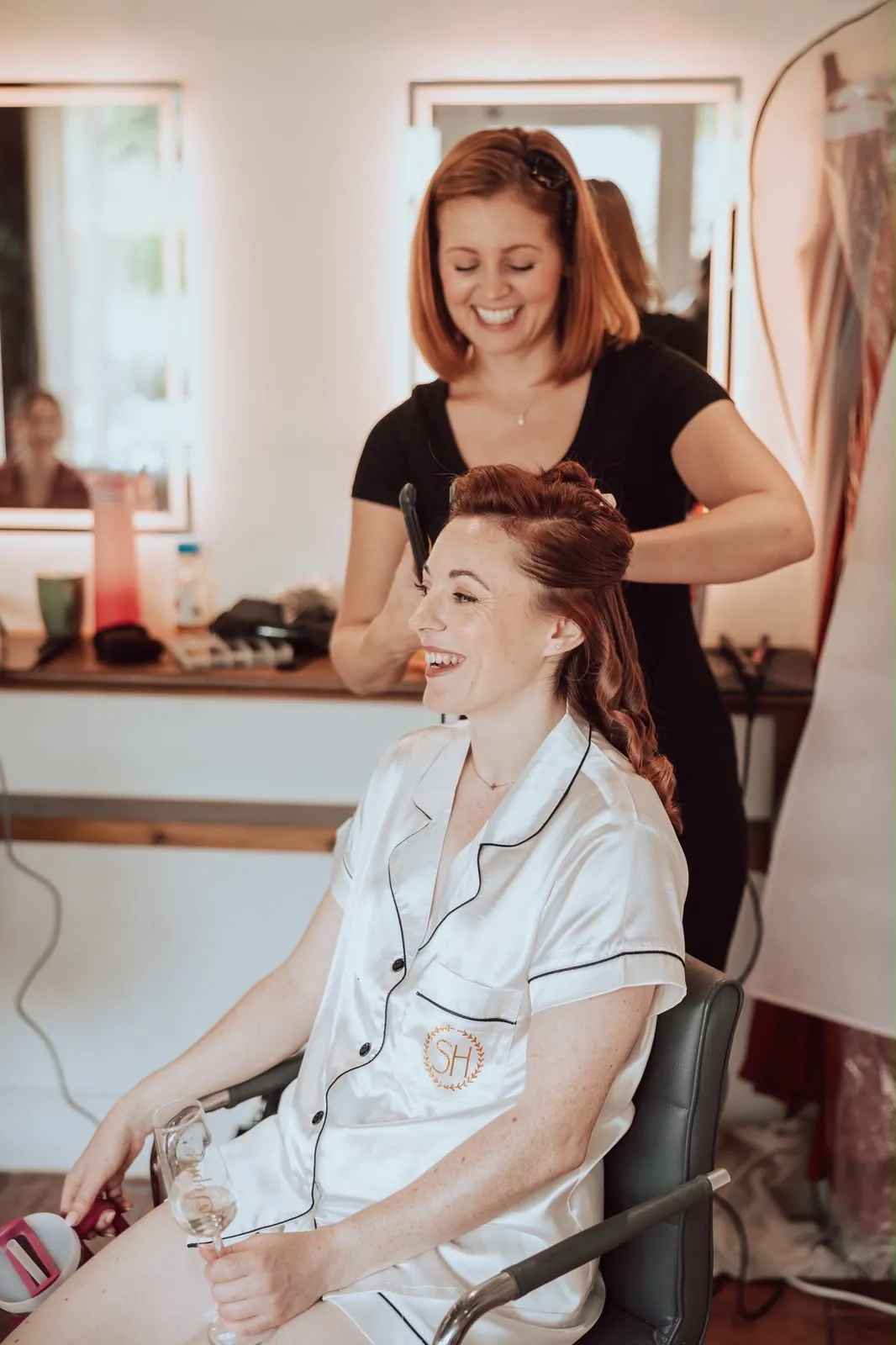 Bride having her hair curled in her bridal pyjamas on the wedding morning by Be Bridal