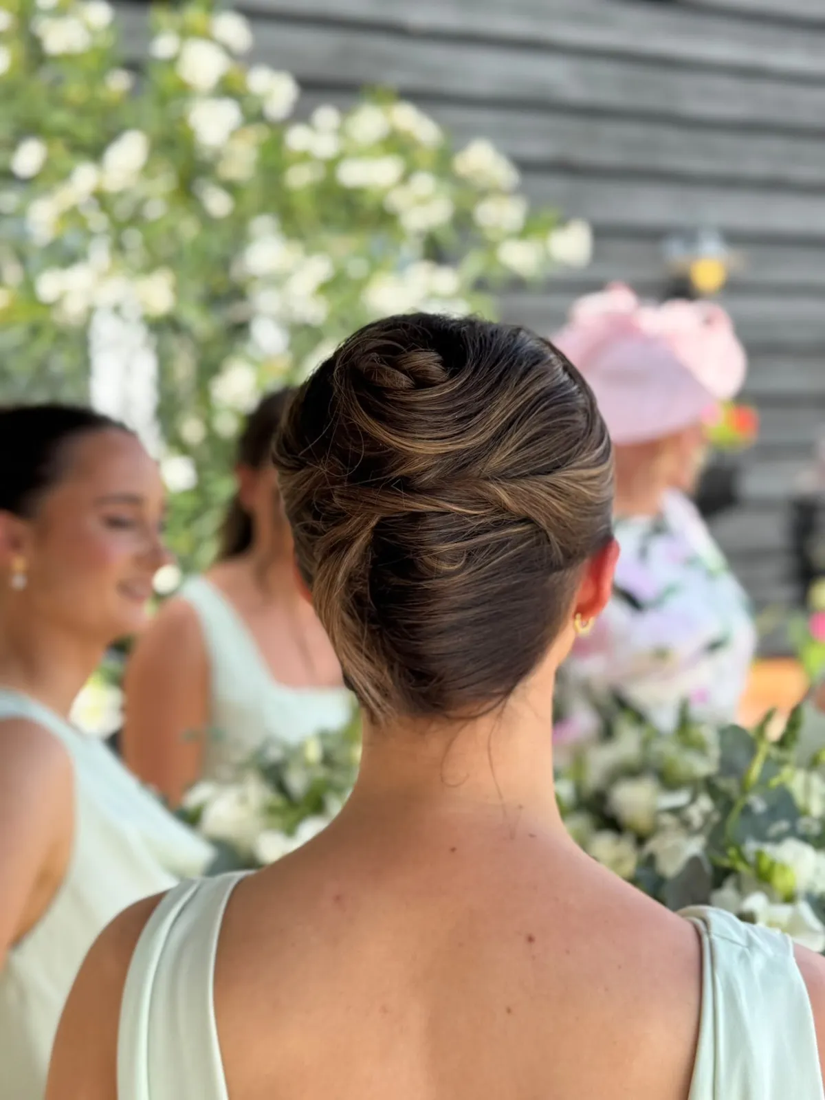 Sleek twisted French chignon for a bridesmaid by Be Bridal